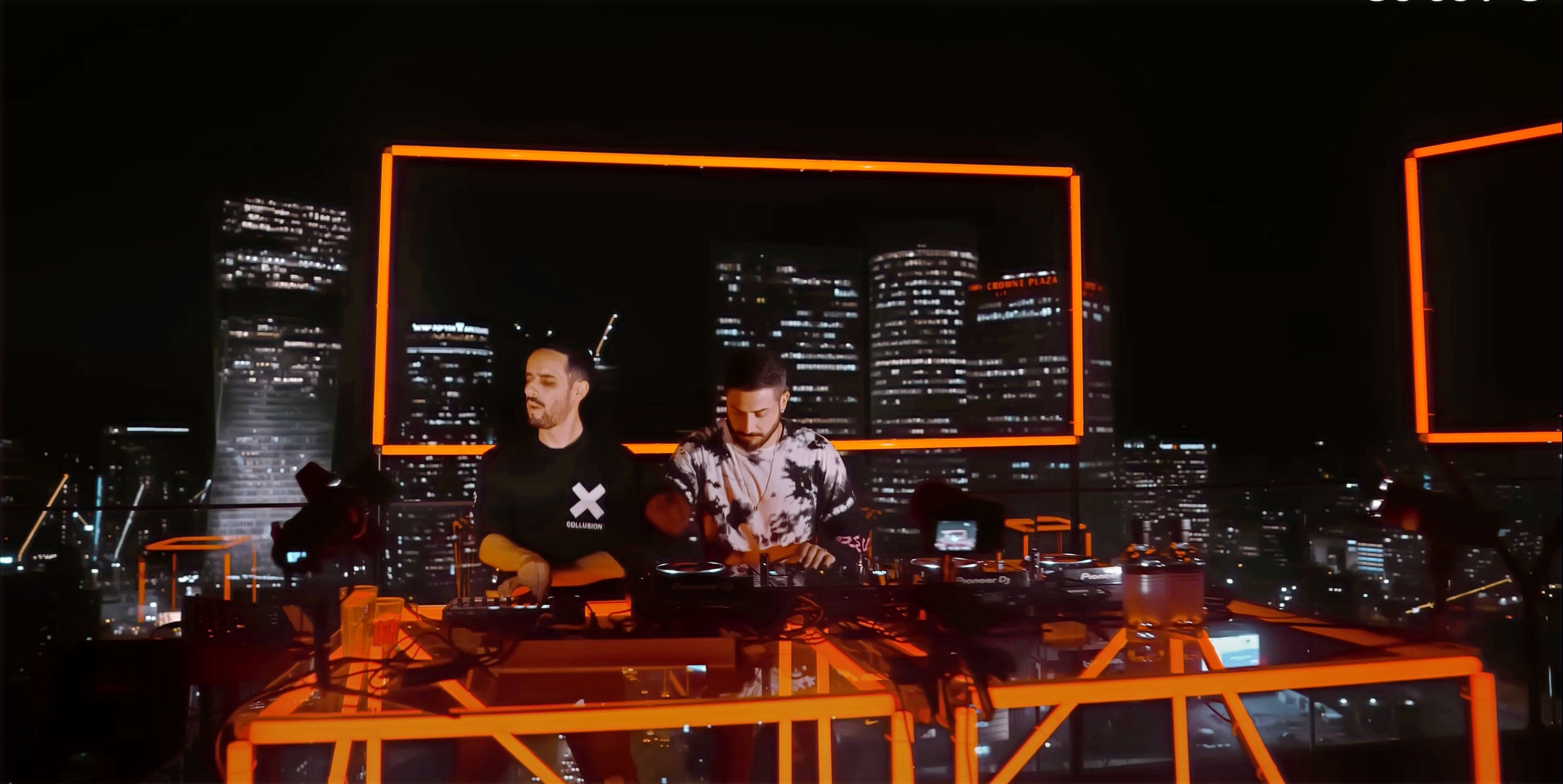 TRIPL performing with the Tel Aviv skyline behind them